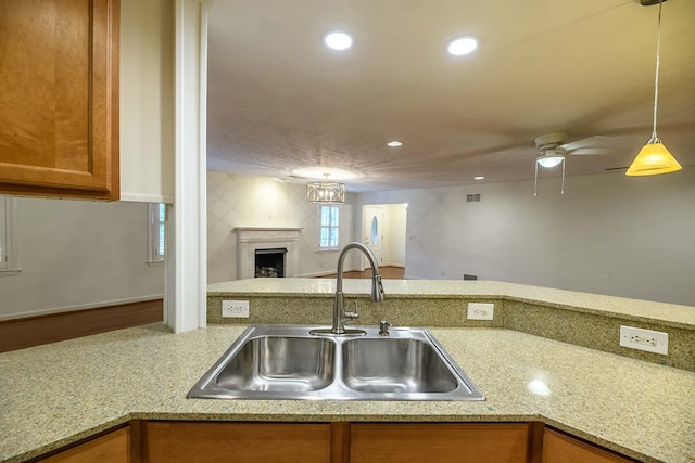 1820 Overlook St, Columbus, GA 31906 - kitchen with brown cabinets, a fireplace, recessed lighting, open floor plan, and ceiling fan