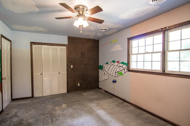 unfurnished bedroom featuring ceiling fan, a closet, and carpet floors