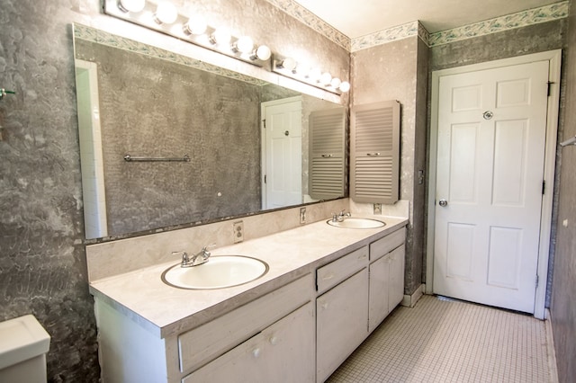 bathroom featuring tile patterned flooring, vanity, and toilet