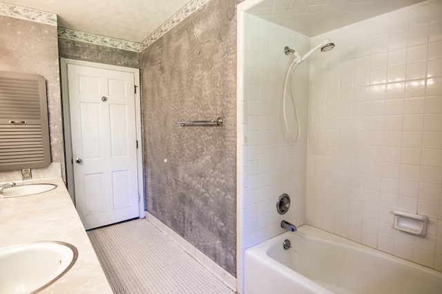 bathroom featuring vanity, tile patterned floors, and tiled shower / bath