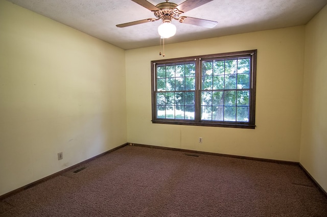 unfurnished room featuring ceiling fan, carpet, and a textured ceiling