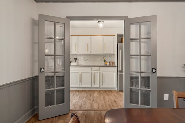 7172 Standing Boy Rd, Columbus, GA 31904 - kitchen featuring white cabinets, light wood-style flooring, backsplash, and high quality fridge