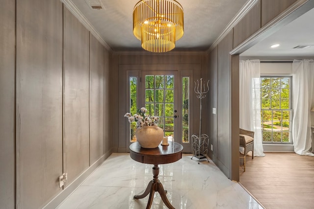 7172 Standing Boy Rd, Columbus, GA 31904 - foyer featuring a decorative wall, ornamental molding, healthy amount of natural light, light marble finish flooring, and a chandelier