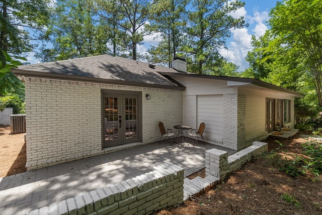 7172 Standing Boy Rd, Columbus, GA 31904 - back of property with brick siding, a chimney, a patio area, a shingled roof, and french doors