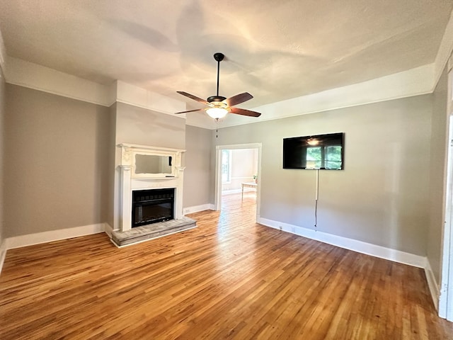 unfurnished living room with ceiling fan and light hardwood / wood-style flooring