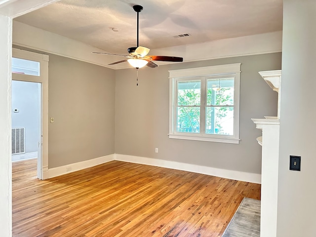 empty room featuring ceiling fan and light wood-type flooring