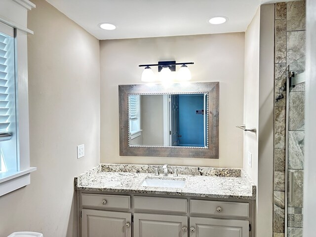 bathroom featuring vanity and an enclosed shower