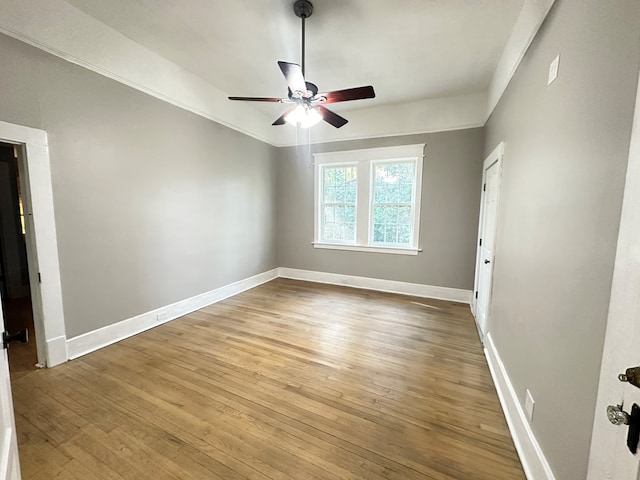 unfurnished room with ceiling fan, ornamental molding, and hardwood / wood-style flooring