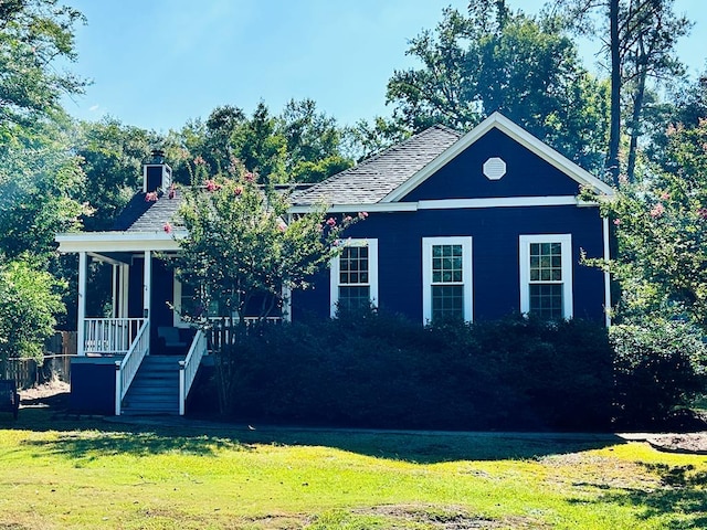 view of front of home featuring covered porch and a front yard