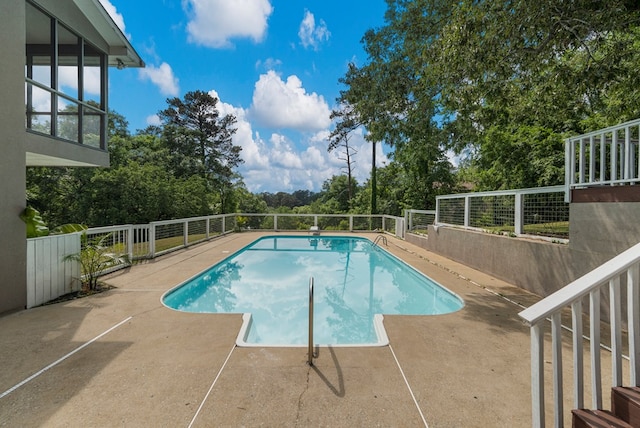 view of pool with fence, a fenced in pool, and a patio area