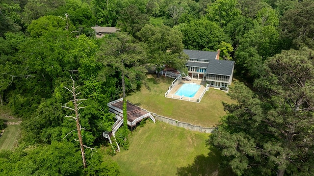 drone / aerial view with a wooded view