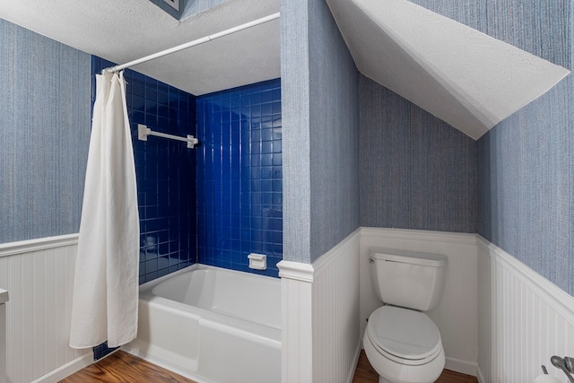 bathroom with wood finished floors and a wainscoted wall