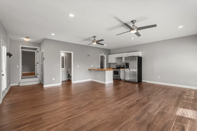 unfurnished living room with dark wood-style flooring, a ceiling fan, baseboards, and recessed lighting