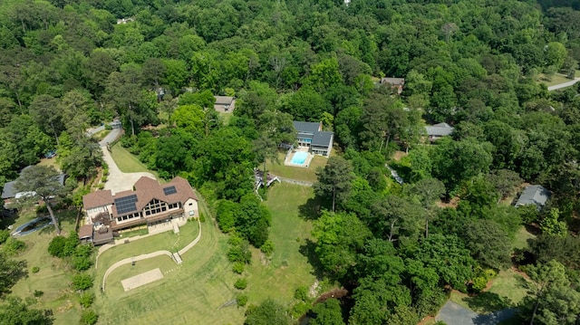 drone / aerial view featuring a wooded view