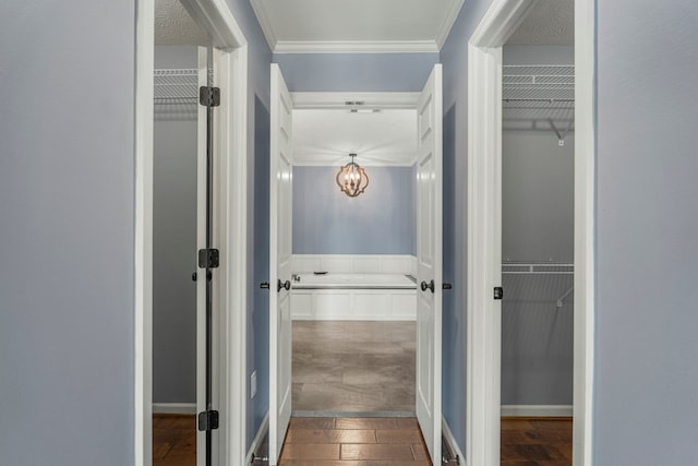 corridor with crown molding, baseboards, and dark wood-style floors