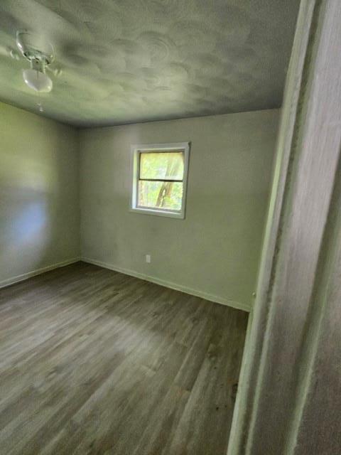 unfurnished room featuring hardwood / wood-style flooring