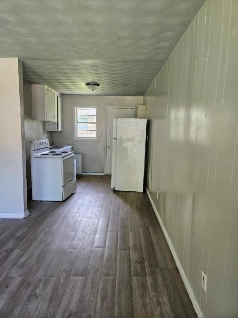 kitchen featuring white appliances and dark hardwood / wood-style floors