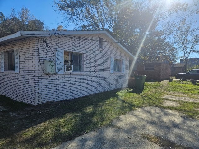 view of side of property featuring a yard