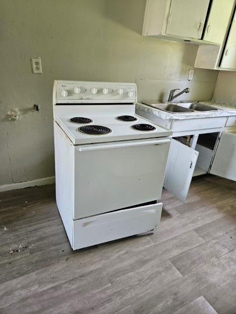 kitchen featuring white cabinets, light hardwood / wood-style floors, white range with electric stovetop, and sink