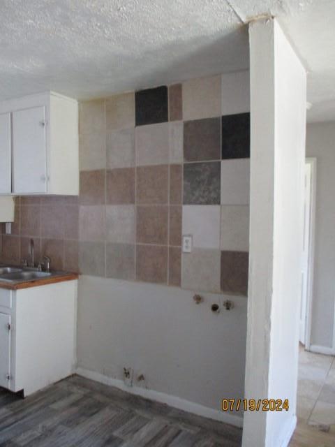 interior space featuring tile walls, dark wood-type flooring, and sink