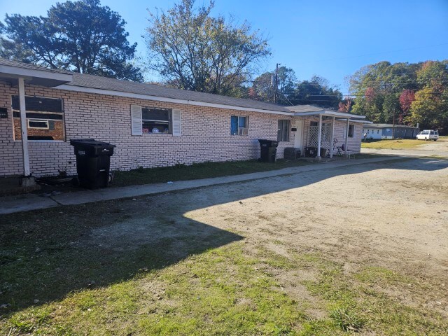 rear view of property featuring a yard