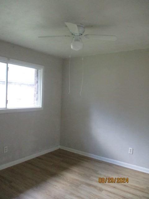 empty room featuring hardwood / wood-style flooring and ceiling fan