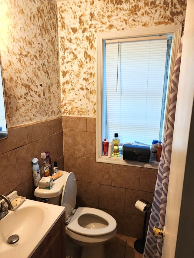 46 Infantry Dr, Columbus, GA 31903 - bathroom with tile walls, wallpapered walls, vanity, wainscoting, and tile patterned floors