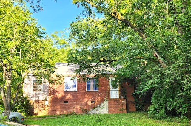 46 Infantry Dr, Columbus, GA 31903 - view of home's exterior with crawl space, a yard, and brick siding