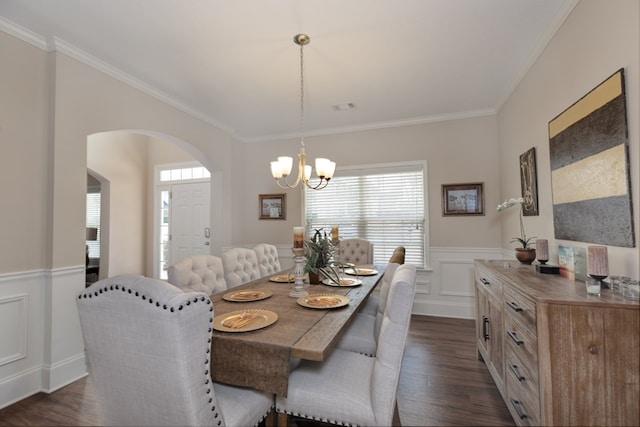 dining area featuring a wainscoted wall, visible vents, dark wood finished floors, and ornamental molding