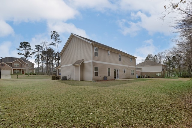 rear view of house featuring a yard and cooling unit