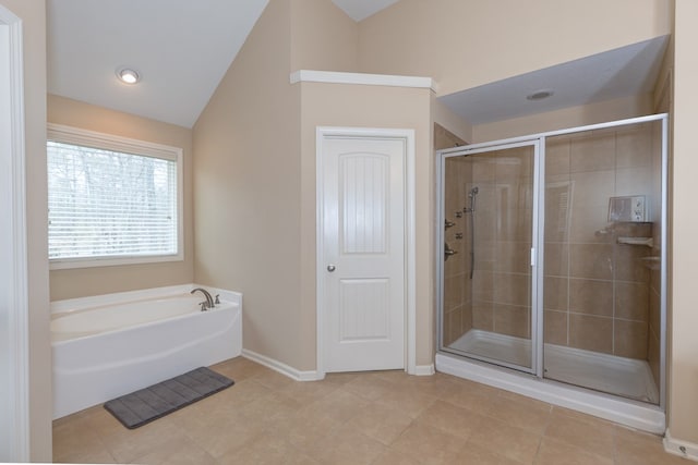 bathroom featuring a garden tub, lofted ceiling, a shower stall, baseboards, and tile patterned floors