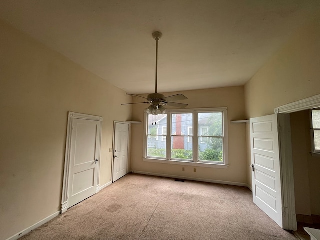 interior space with light carpet and ceiling fan