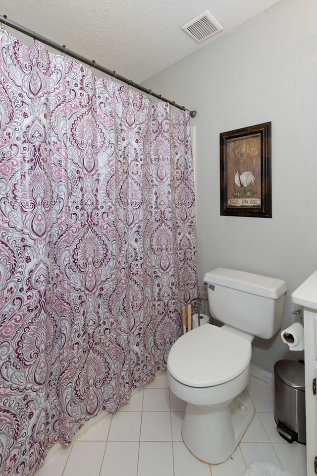 full bath with tile patterned flooring, toilet, visible vents, and a textured ceiling