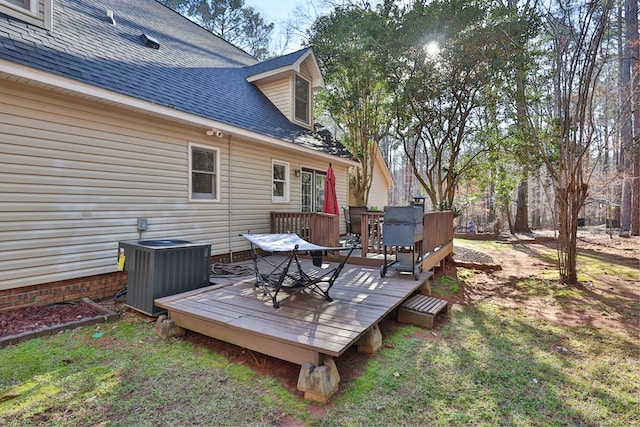 wooden terrace with cooling unit and a yard