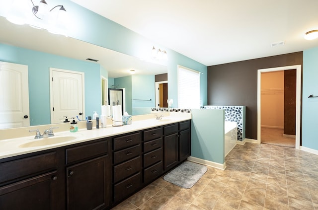 9 Red Maple St, Phenix City, AL 36869 - full bathroom with a garden tub, double vanity, a stall shower, and a spacious closet