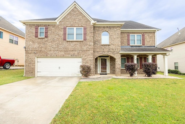 9 Red Maple St, Phenix City, AL 36869 - view of front of property with an attached garage, a front yard, concrete driveway, and brick siding