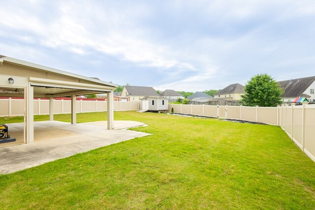 9 Red Maple St, Phenix City, AL 36869 - view of yard with a shed, a patio area, an outdoor structure, and a residential view