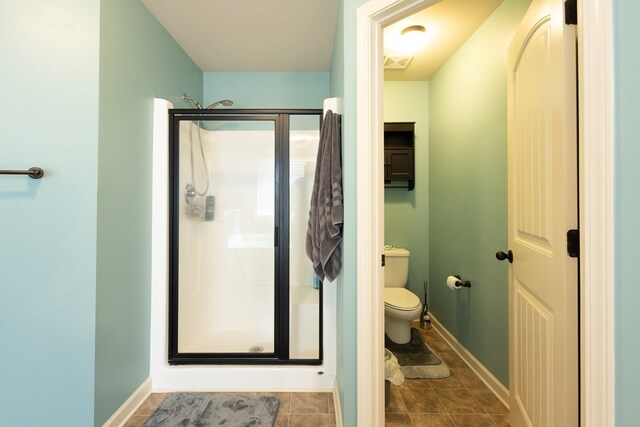 9 Red Maple St, Phenix City, AL 36869 - full bathroom featuring a stall shower, toilet, baseboards, and tile patterned flooring