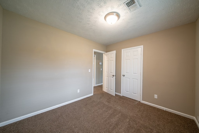 unfurnished bedroom featuring a closet, carpet, and a textured ceiling