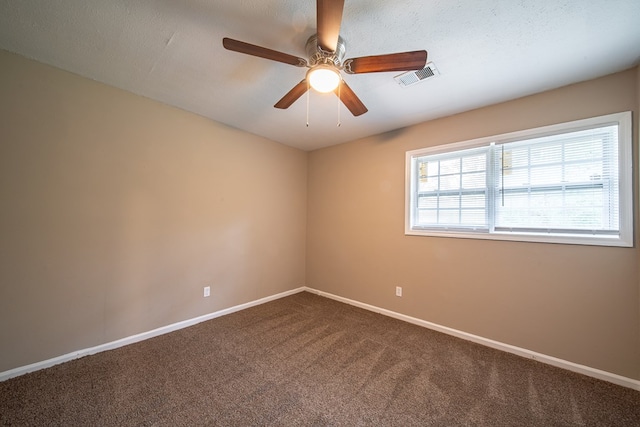 empty room featuring carpet, a textured ceiling, and ceiling fan