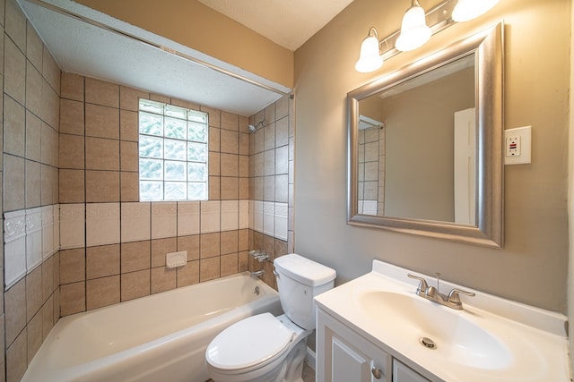 full bathroom featuring vanity, toilet, a textured ceiling, and tiled shower / bath