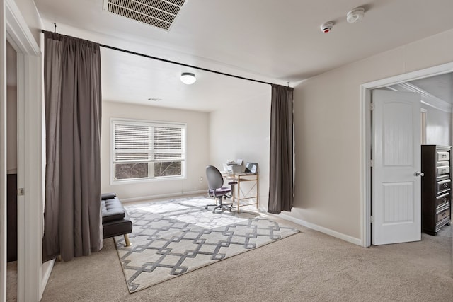 carpeted office space with baseboards and visible vents