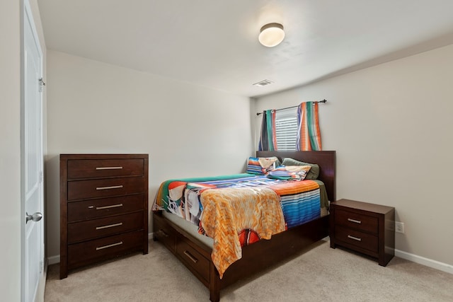 bedroom with visible vents, baseboards, and light colored carpet