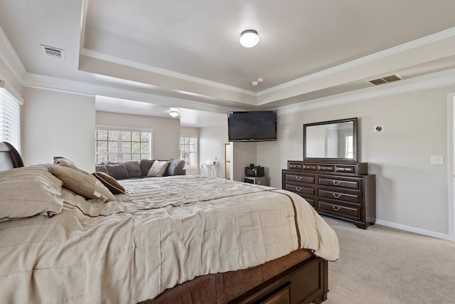 bedroom featuring visible vents, light carpet, a raised ceiling, and baseboards