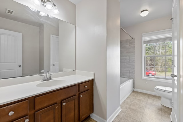 bathroom featuring visible vents, baseboards, toilet, shower / tub combination, and vanity