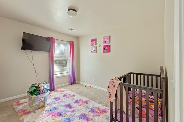 carpeted bedroom featuring baseboards and visible vents