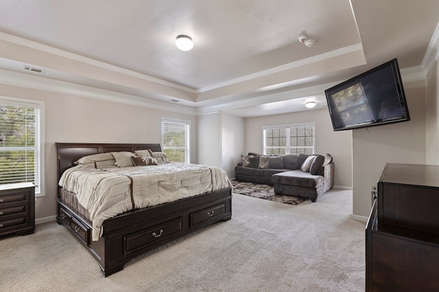 bedroom featuring visible vents, crown molding, baseboards, a tray ceiling, and light carpet