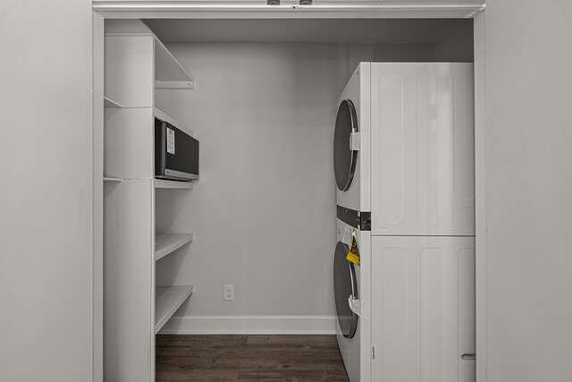989 Lee Road 0213, Phenix City, AL 36870 - washroom featuring stacked washing machine and dryer and wood finished floors