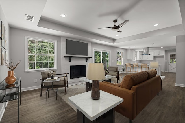 989 Lee Road 0213, Phenix City, AL 36870 - living area featuring a tray ceiling, ceiling fan, dark wood finished floors, recessed lighting, and a brick fireplace