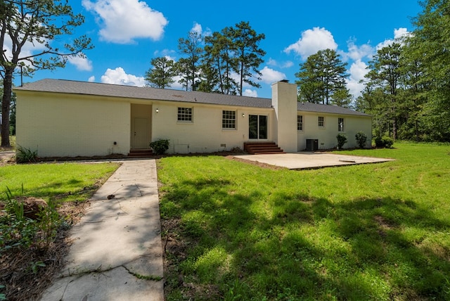 989 Lee Road 0213, Phenix City, AL 36870 - back of house featuring entry steps, crawl space, a patio area, a chimney, and a lawn
